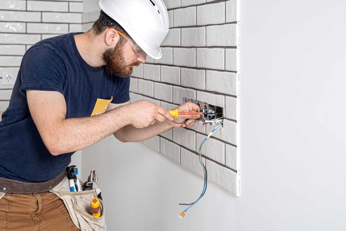 Electrician working in kitchen